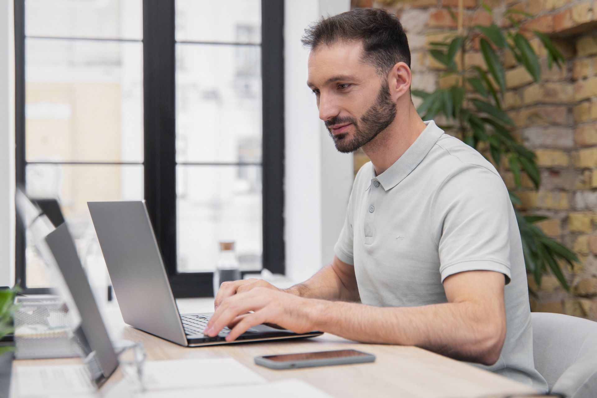 Professional reviewing content topics on a laptop — picking what to write next